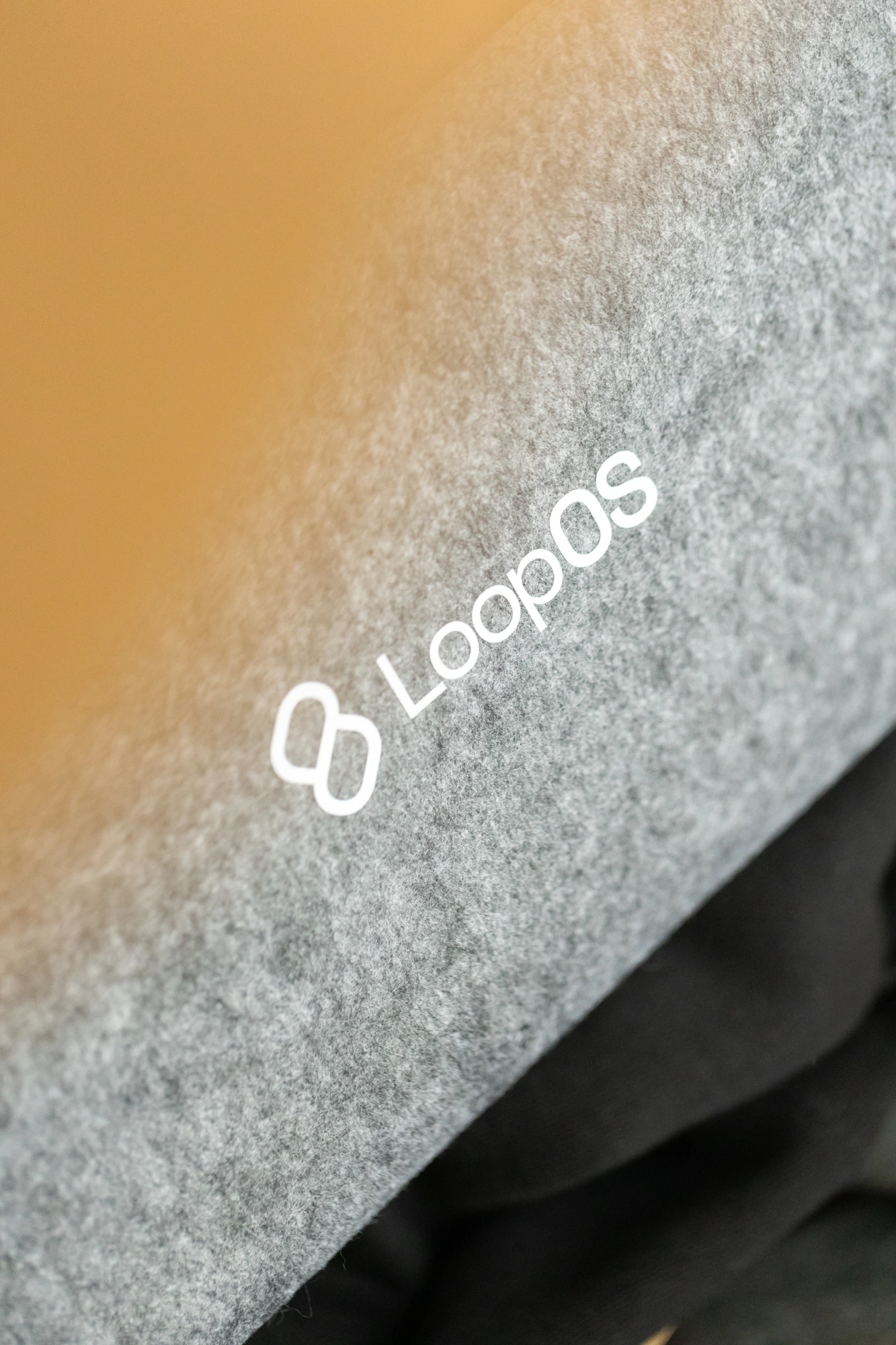 The LoopOS mark printed on grey felt